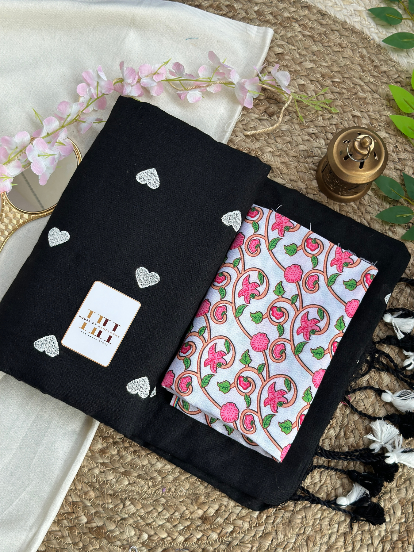 Rich black cotton handloom saree with white floral printed blouse